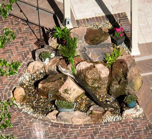 Outdoor kitchen with stainless steel grill, stone countertops, and ambient lighting, overlooking a scenic view, enhancing outdoor living and hosting experiences.