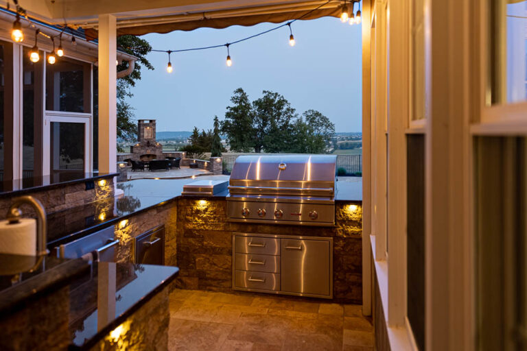 Outdoor kitchen beside a paver patio