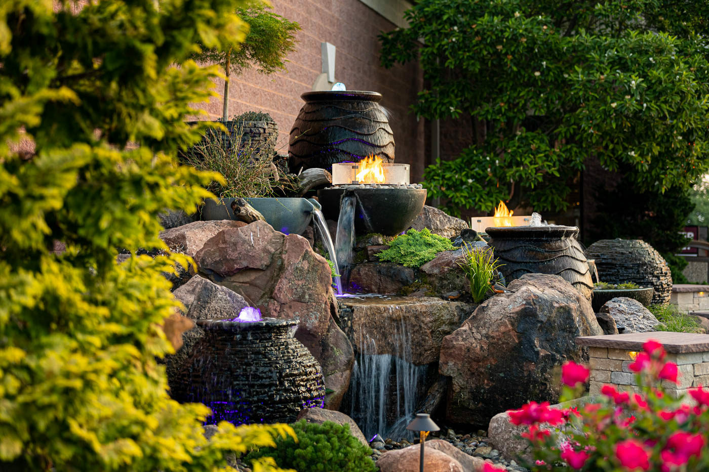 Water feature with rockwork and surrounding flowers