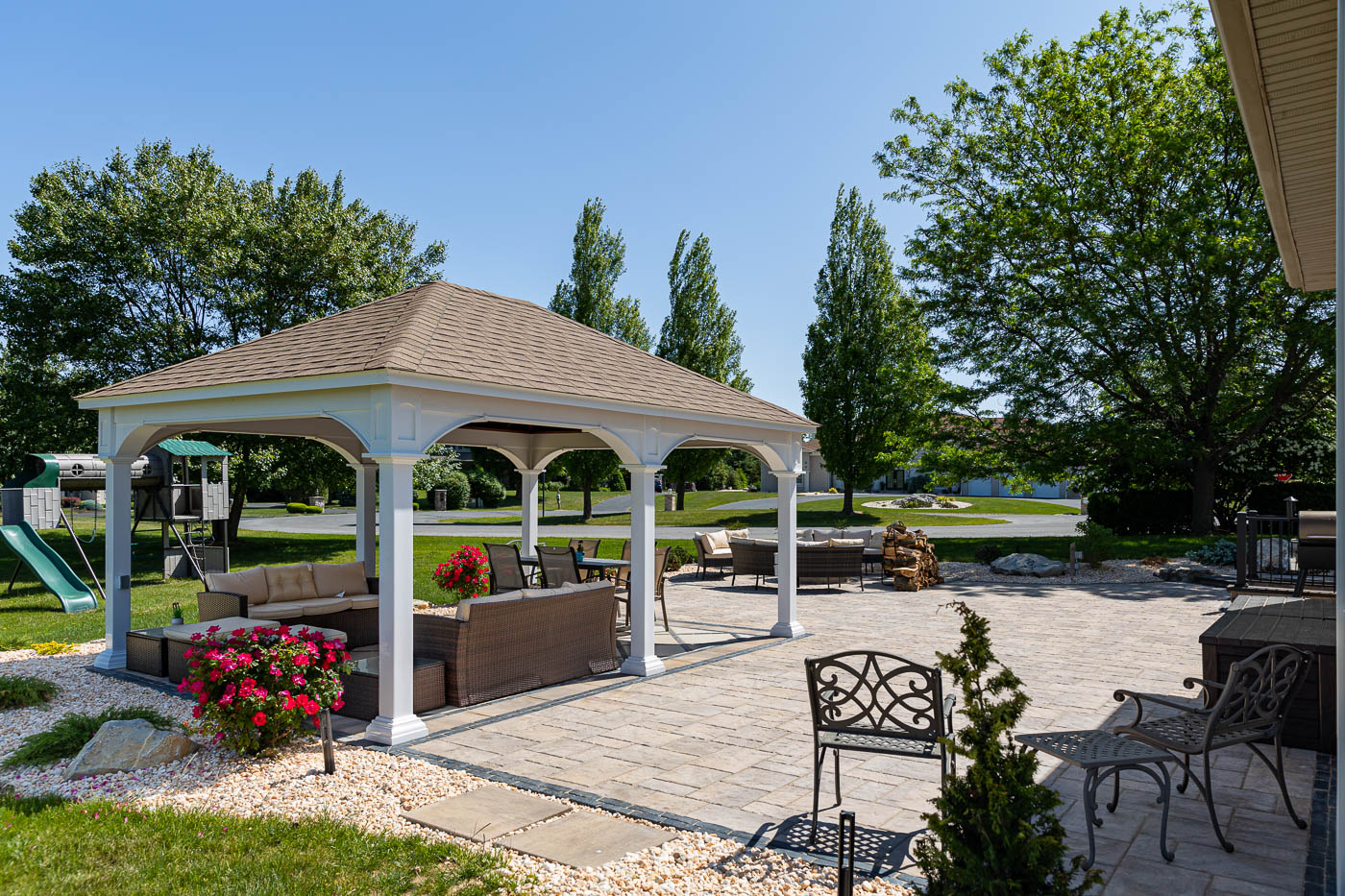 Gazebo with seating beside a pool patio